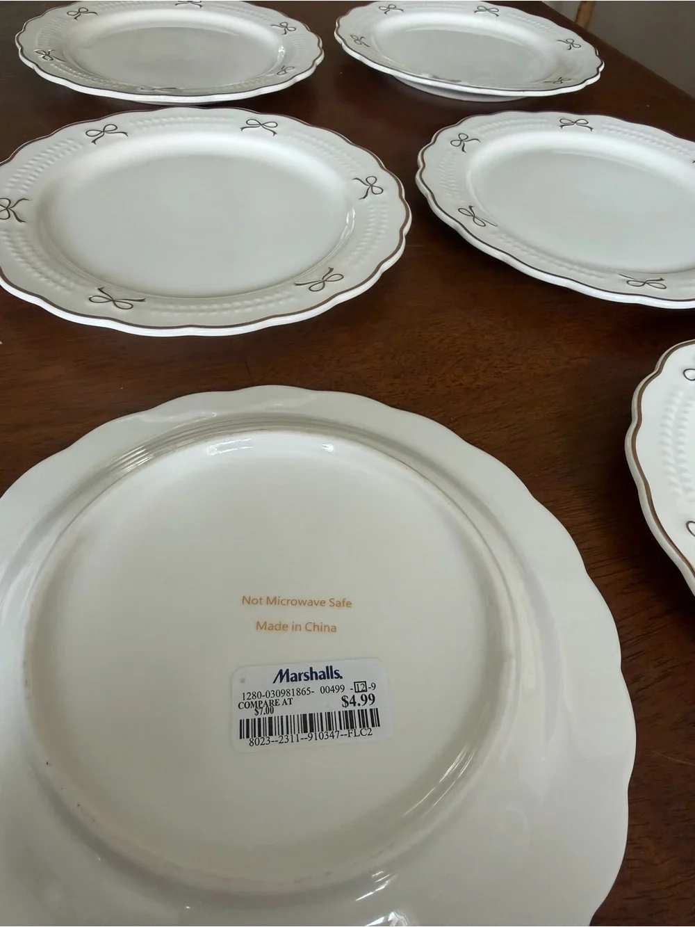 Set of White Scalloped Dinner Plates with Gold Bow Details